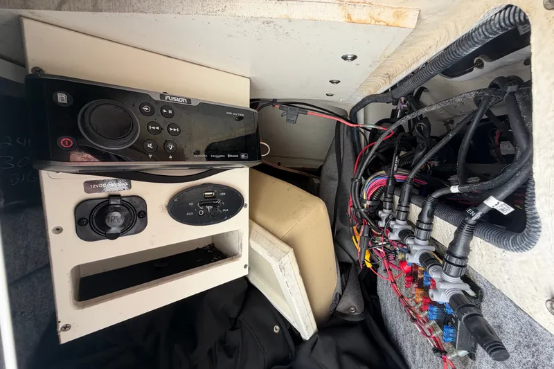 Slide: The Image of 2014 Sea Ray 240 Sundeck interior wiring and control panel with Fusion stereo system. - 46