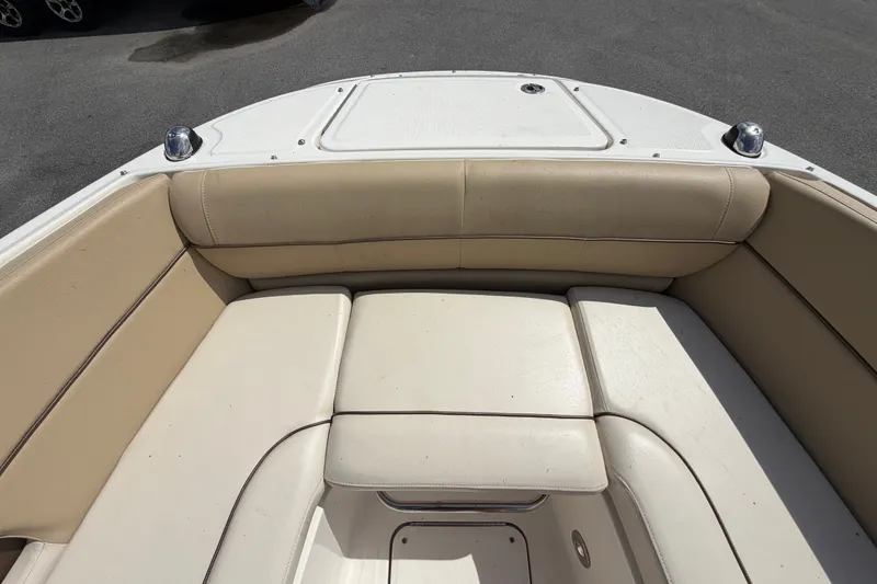 Slide: The Image of 2014 Sea Ray 240 Sundeck boat interior with beige cushioned seating. - 52