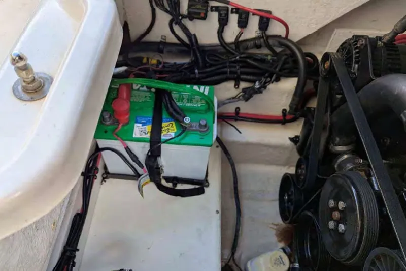 Slide: The Image of Engine compartment of a 2014 Searay SDX 240 boat, featuring battery and wiring. - 8