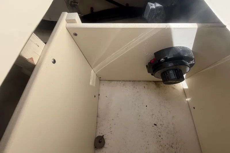 Slide: The Image of An open storage compartment with a black rotary knob on the side. - 19