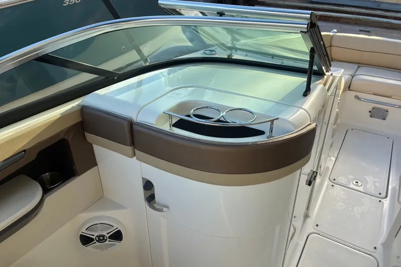 Slide: The Image of 2014 Sea Ray 240 Sundeck interior with seating and cup holders. - 32