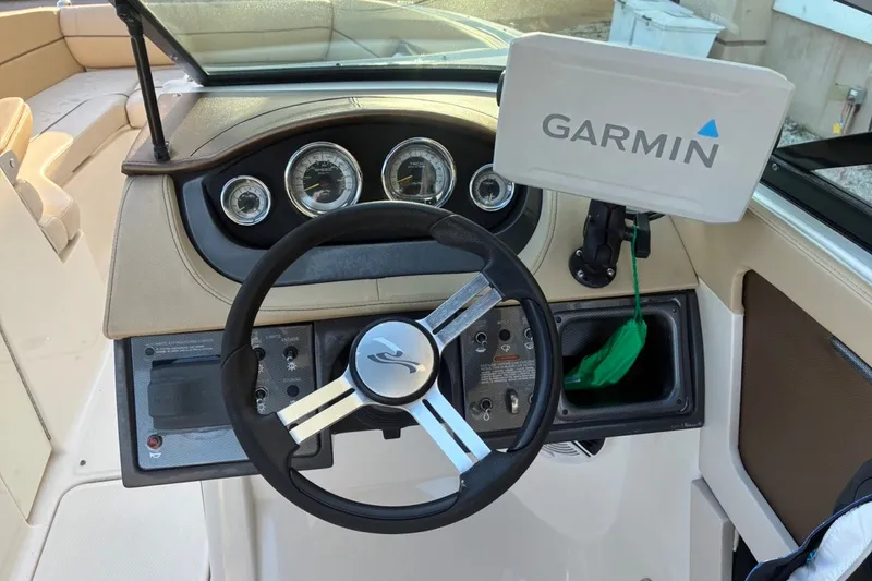 Slide: The Image of Steering wheel and dashboard of a 2014 Sea Ray 240 Sundeck with Garmin navigation. - 42