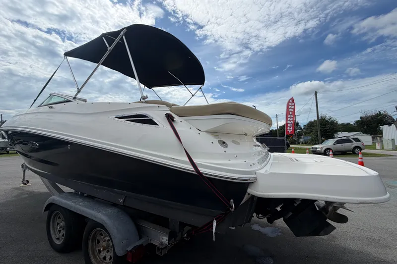 Slide: The Image of 2014 Sea Ray 240 Sundeck boat on trailer under cloudy sky. - 7