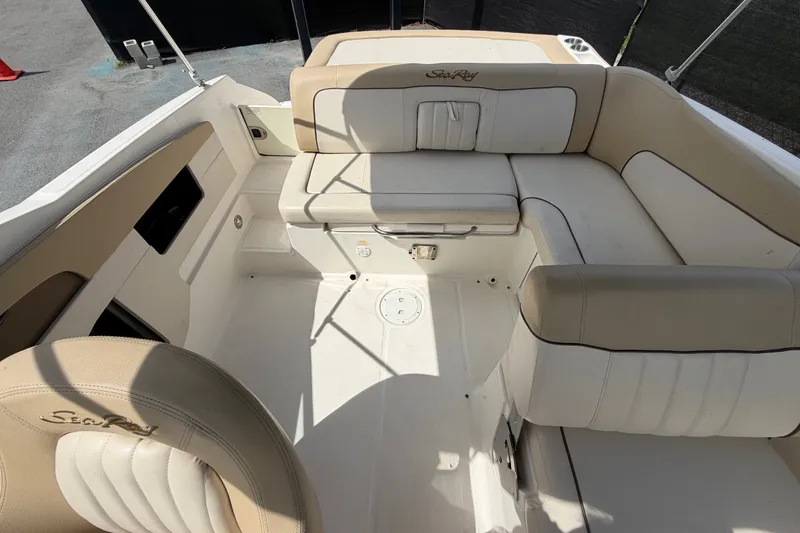 Slide: The Image of 2014 Sea Ray 240 Sundeck interior with beige seating and spacious layout. - 69