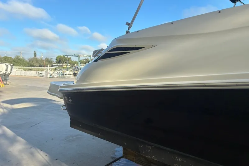 Slide: The Image of 2014 Sea Ray 240 Sundeck boat on dry dock under clear blue sky. - 6