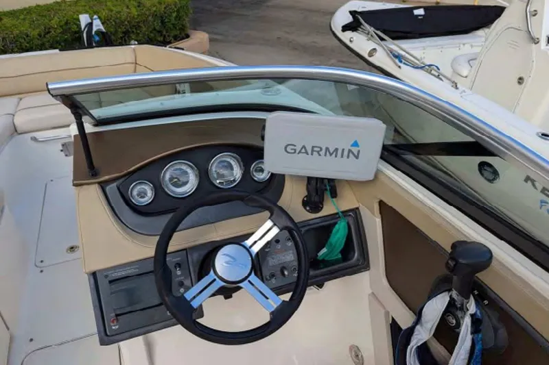 Slide: The Image of 2014 Searay SDX 240 boat dashboard with Garmin navigation system and steering wheel. - 6