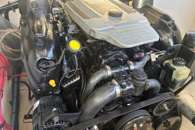 Slide: The Image of Engine of a 2014 Sea Ray 240 Sundeck boat, showcasing detailed components. - 52