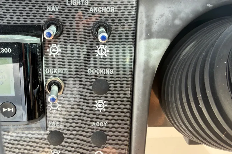 Slide: The Image of Control panel of a 2014 Sea Ray 240 Sundeck boat with switches and dials. - 35