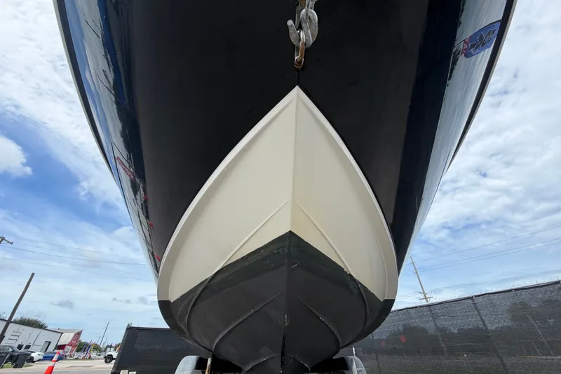 Slide: The Image of 2014 Sea Ray 240 Sundeck boat hull, viewed from below against a cloudy sky. - 11