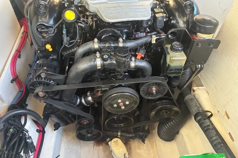 Slide: The Image of Engine of a 2014 Sea Ray 240 Sundeck boat, showcasing belts and components. - 51