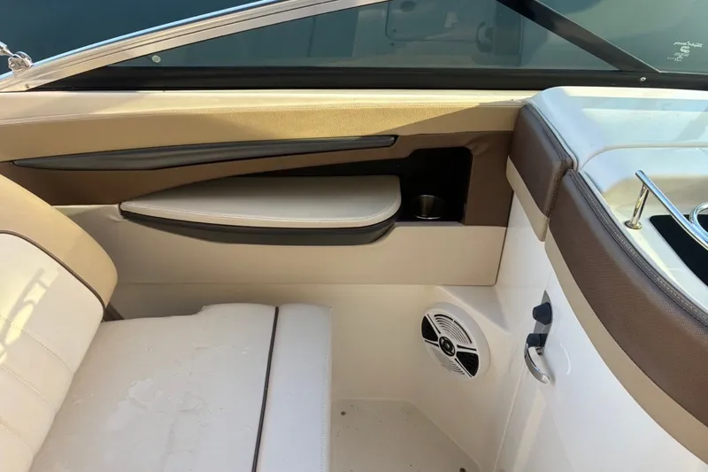 Slide: The Image of Interior view of a 2014 Sea Ray 240 Sundeck boat, featuring beige seating and speaker. - 34