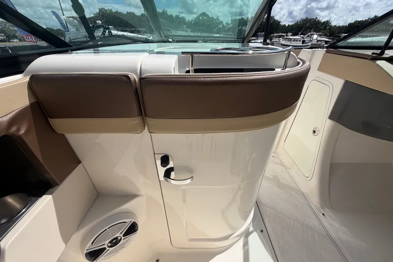 Slide: The Image of 2014 Sea Ray 240 Sundeck interior with seating and speaker, showcasing luxury design. - 26