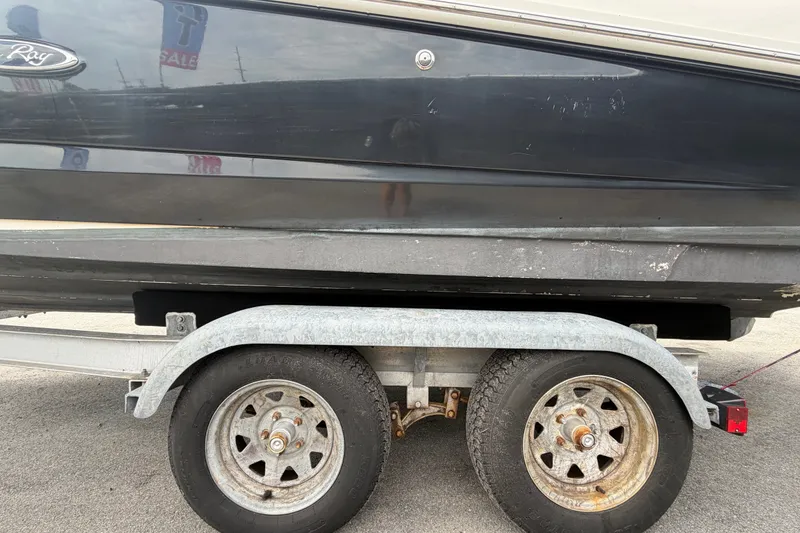 Slide: The Image of 2014 Sea Ray 240 Sundeck on trailer, showing hull and wheels. - 88