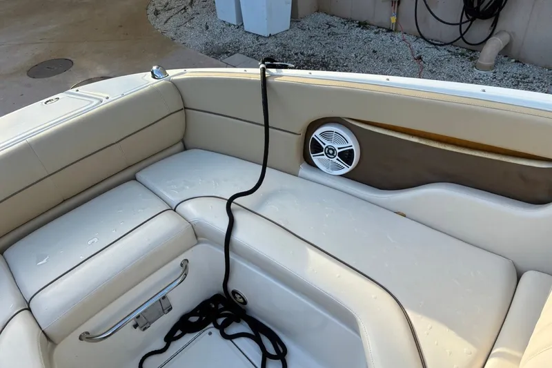 Slide: The Image of Interior of 2014 Sea Ray 240 Sundeck with beige seating and speaker. - 20