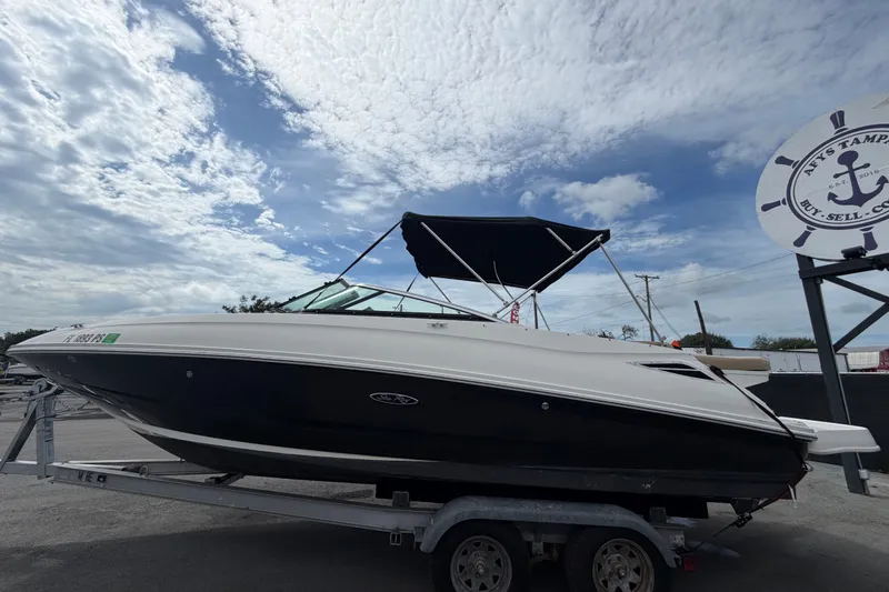Slide: The Image of 2014 Sea Ray 240 Sundeck boat on trailer under cloudy sky. - 8