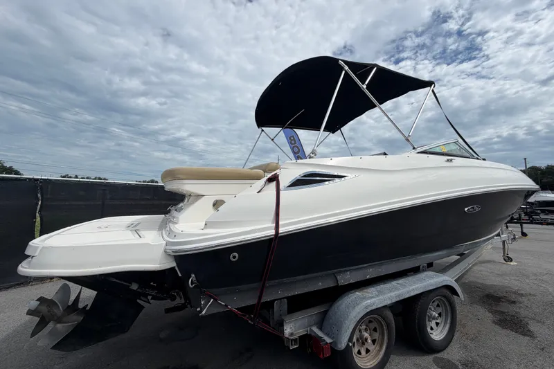 Slide: The Image of 2014 Sea Ray 240 Sundeck boat on trailer under cloudy sky. - 3