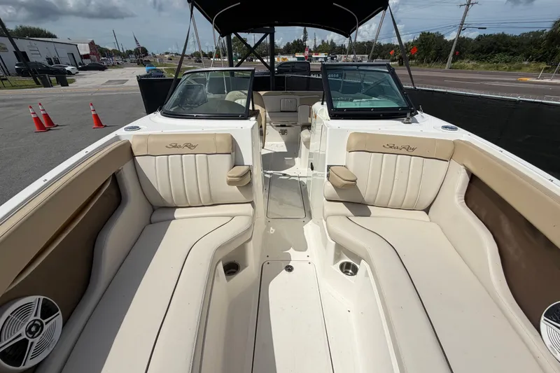 Slide: The Image of 2014 Sea Ray 240 Sundeck interior with beige seating and open deck layout. - 64