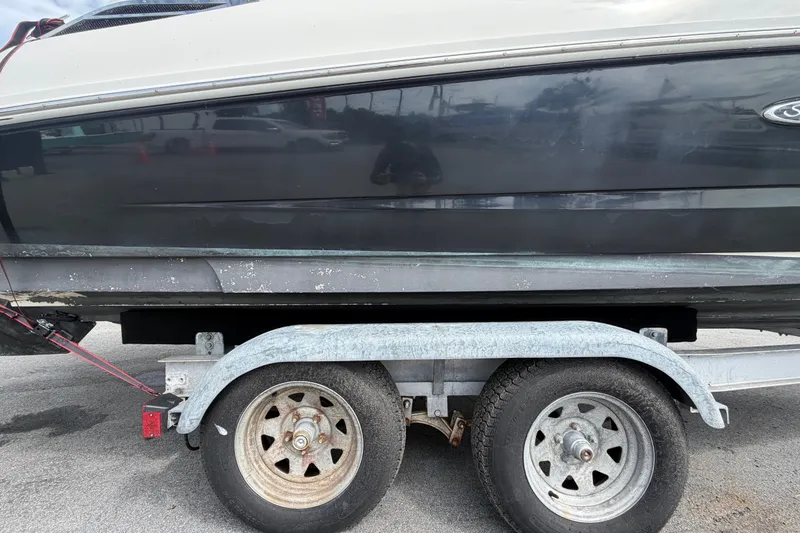 Slide: The Image of 2014 Sea Ray 240 Sundeck on trailer, showing hull and wheels. - 89