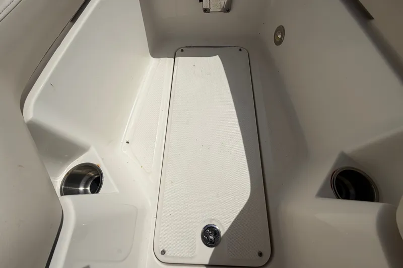 Slide: The Image of Interior view of a 2014 Sea Ray 240 Sundeck boat, featuring storage compartment. - 50