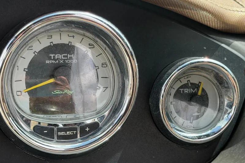 Slide: The Image of Tachometer and trim gauge on 2014 Sea Ray 240 Sundeck dashboard. - 38