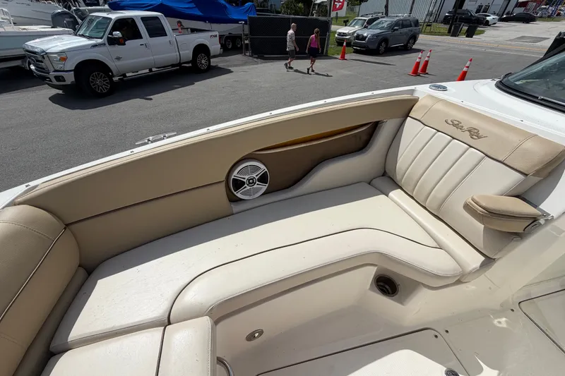 Slide: The Image of 2014 Sea Ray 240 Sundeck interior with beige seating and speaker detail. - 55