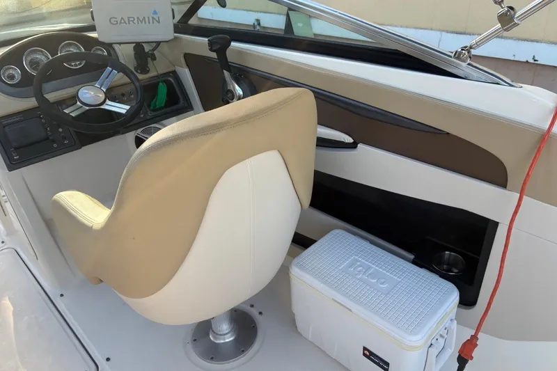 Slide: The Image of 2014 Sea Ray 240 Sundeck helm with Garmin GPS and Igloo cooler. - 30