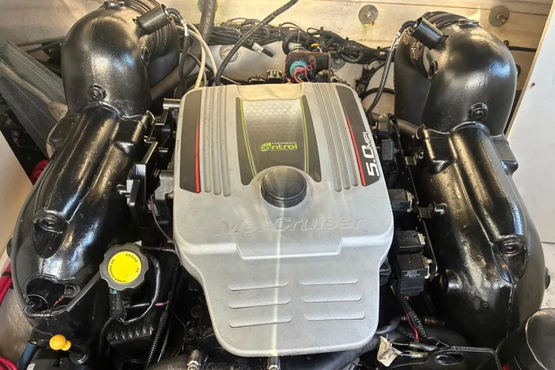 Slide: The Image of Engine of a 2014 Sea Ray 240 Sundeck boat, featuring a MerCruiser 5.0 MPI. - 53