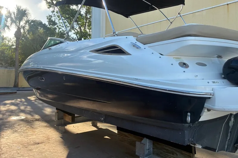 Slide: The Image of 2014 Sea Ray 240 Sundeck boat on display, featuring sleek design and black hull. - 9