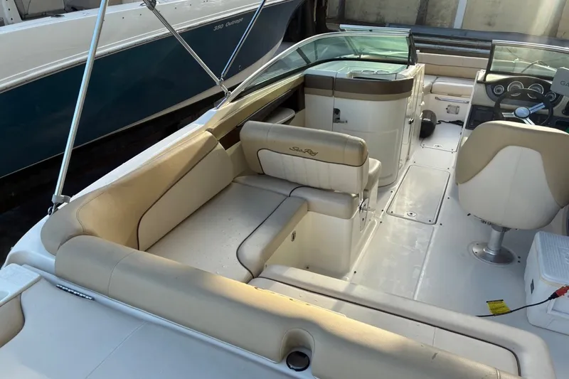 Slide: The Image of 2014 Sea Ray 240 Sundeck interior with beige seating and modern dashboard. - 28