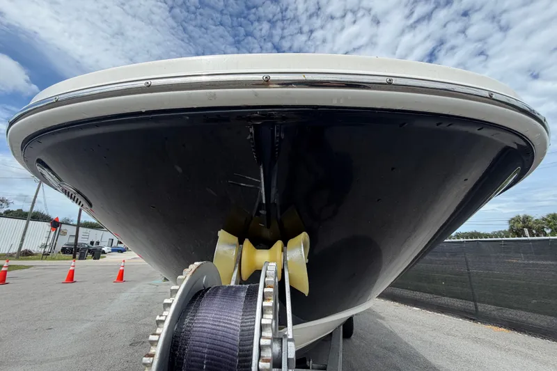 Slide: The Image of 2014 Sea Ray 240 Sundeck boat on trailer, viewed from the front under a cloudy sky. - 10
