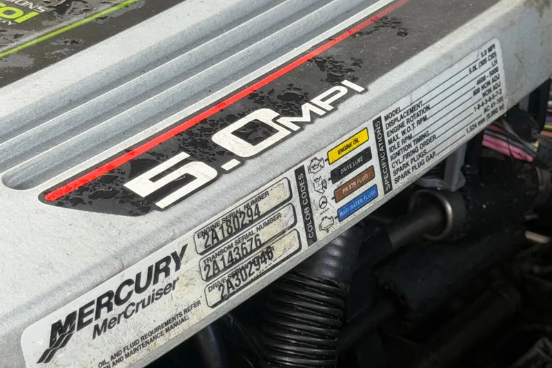 Slide: The Image of Engine cover of a 2014 Sea Ray 240 Sundeck with 5.0 MPI label. - 87