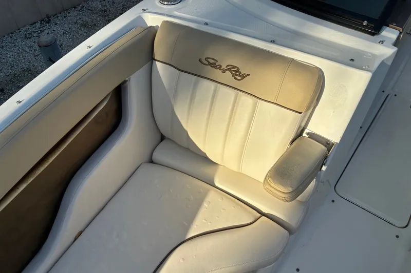 Slide: The Image of 2014 Sea Ray 240 Sundeck boat seat with beige upholstery and armrest. - 25