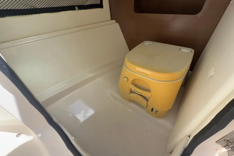 Slide: The Image of Interior of 2014 Sea Ray 240 Sundeck with portable toilet. - 29