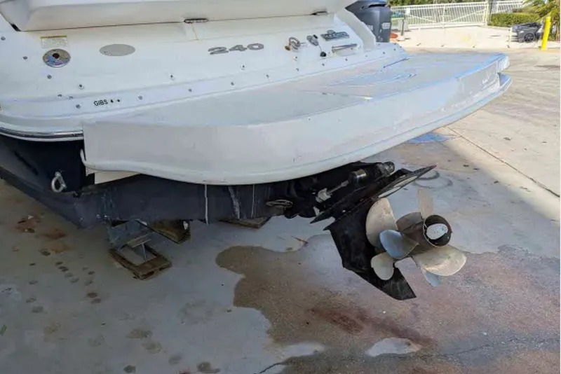 Slide: The Image of 2014 Searay SDX 240 boat stern with visible propeller and swim platform. - 3