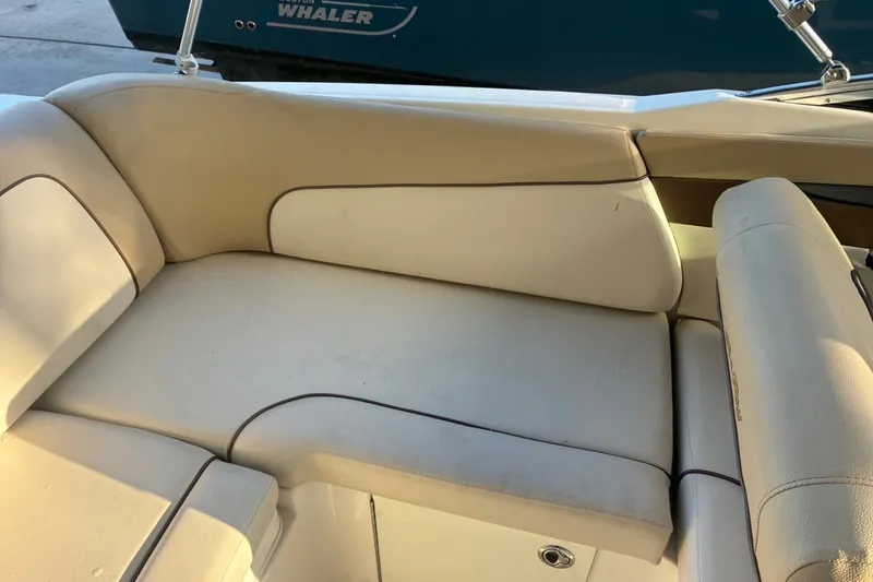 Slide: The Image of 2014 Sea Ray 240 Sundeck interior seating with beige upholstery. - 38