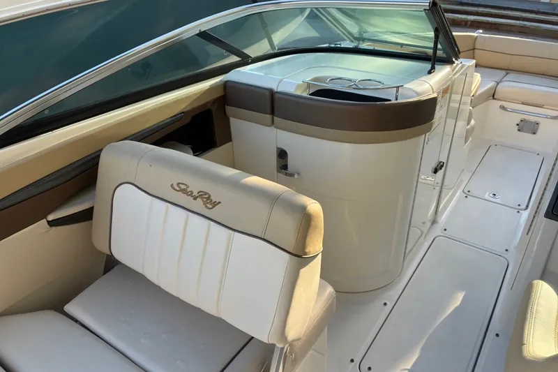 Slide: The Image of 2014 Sea Ray 240 Sundeck interior with seating and helm, showcasing luxury design. - 37