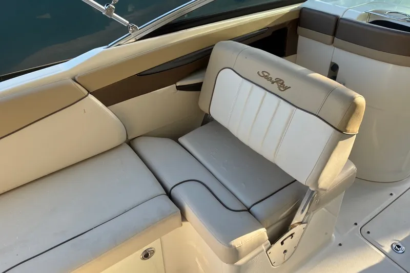 Slide: The Image of 2014 Sea Ray 240 Sundeck interior with beige seating and embroidered logo. - 36