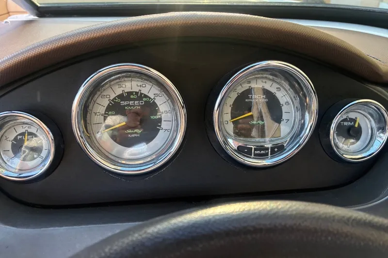 Slide: The Image of Dashboard of a 2014 Sea Ray 240 Sundeck boat with speedometer and tachometer. - 45