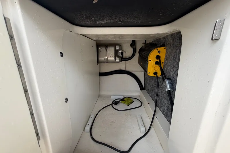 Slide: The Image of Storage compartment of a 2014 Sea Ray 240 Sundeck boat with electrical components. - 73