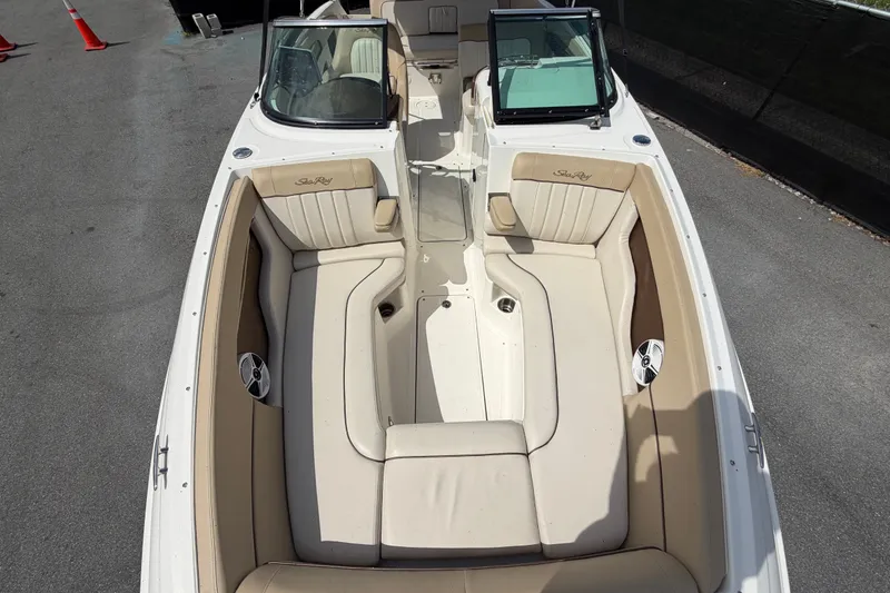 Slide: The Image of 2014 Sea Ray 240 Sundeck boat interior with beige seating and open deck layout. - 61