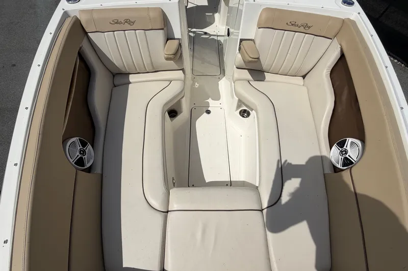 Slide: The Image of 2014 Sea Ray 240 Sundeck interior with beige seating and built-in speakers. - 63