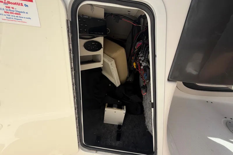 Slide: The Image of Interior view of a 2014 Sea Ray 240 Sundeck storage compartment with wiring and equipment. - 45