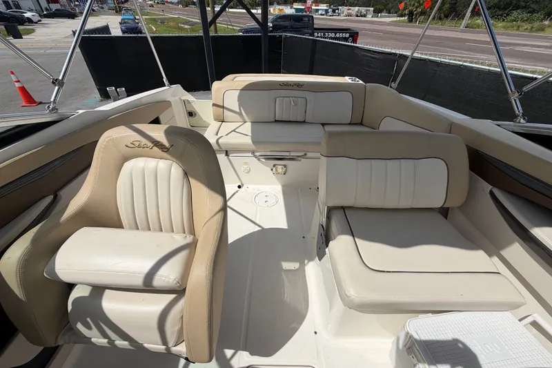 Slide: The Image of 2014 Sea Ray 240 Sundeck interior with beige seating and spacious layout. - 68