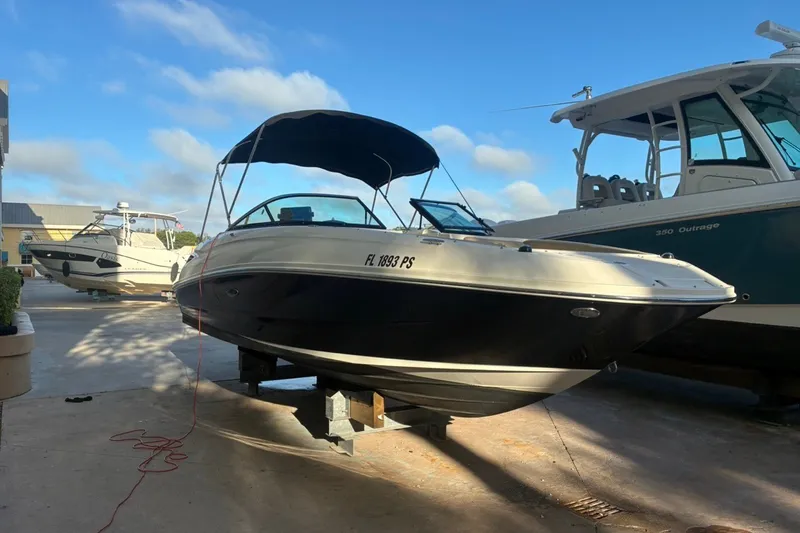 Slide: The Image of 2014 Sea Ray 240 Sundeck boat on display, featuring sleek design and canopy. - 2