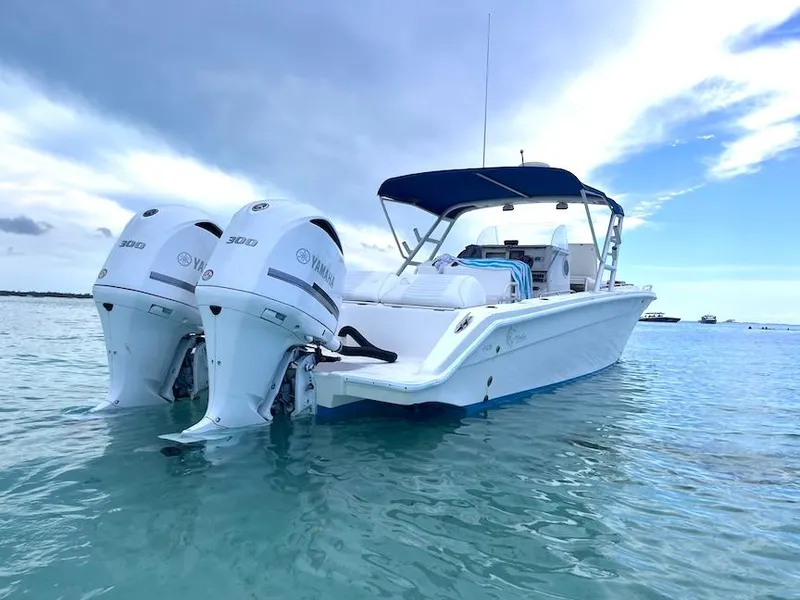 Slide: The Image of 2005 Marlago F35 boat with twin Yamaha engines on calm water. - 0
