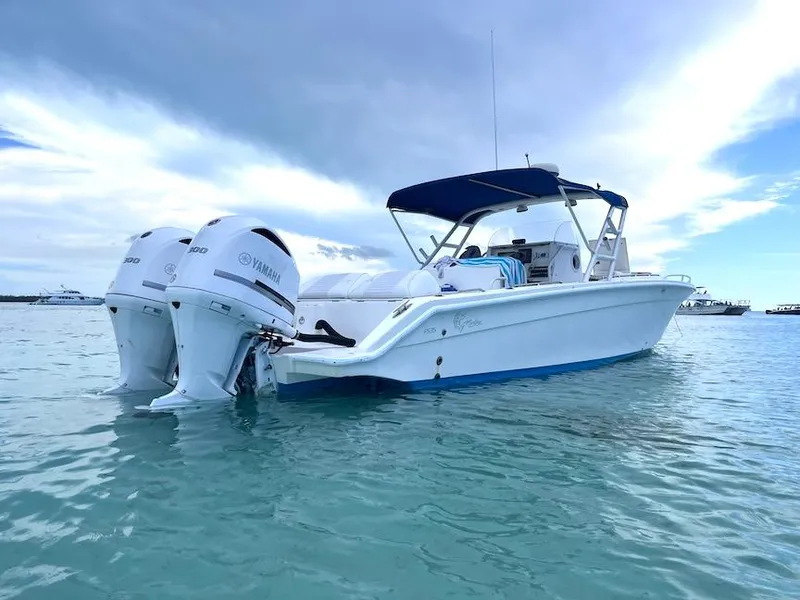 Slide: The Image of 2005 Marlago F35 boat with twin Yamaha engines on calm water. - 1