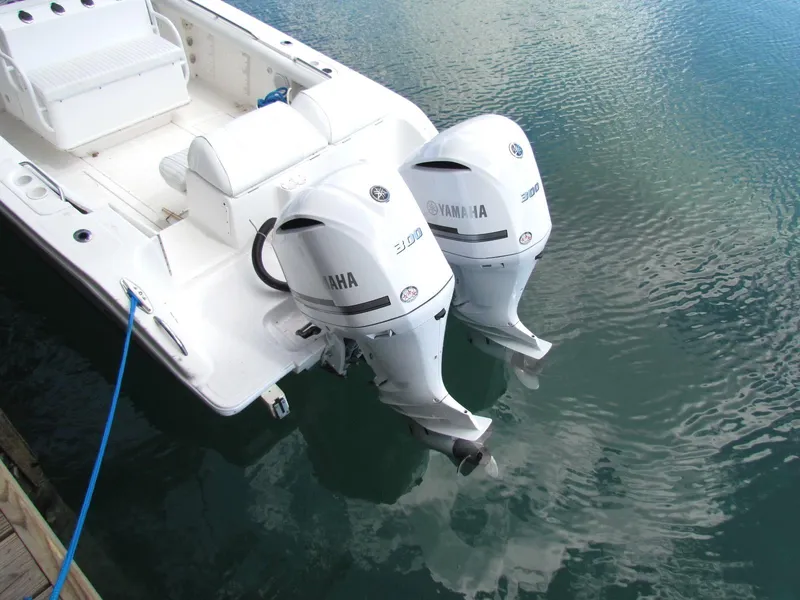Slide: The Image of Marlago F35 boat with twin Yamaha 300 outboard engines, docked on calm water. - 9