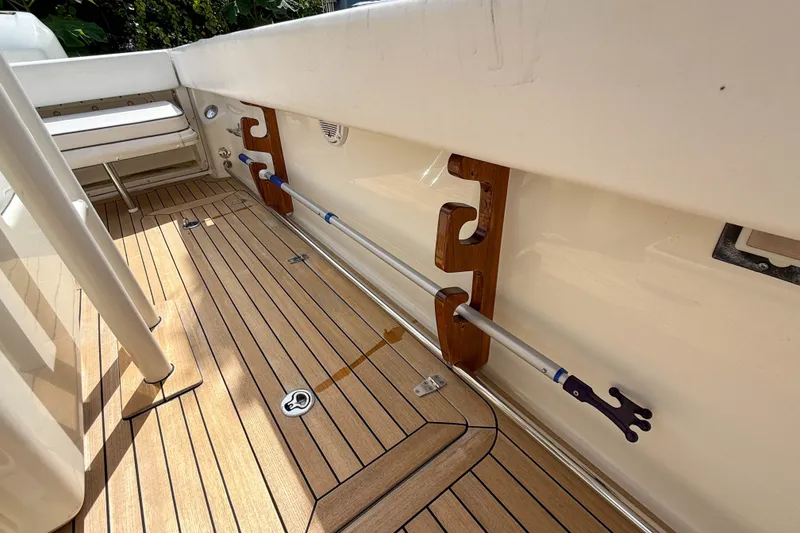 Slide: The Image of 2013 Boston Whaler 32 Justice boat interior with wooden deck and mounted equipment. - 25