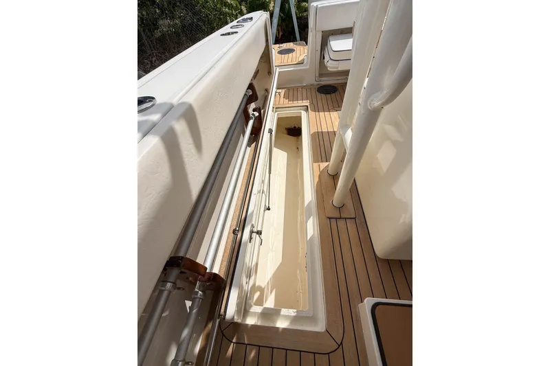 Slide: The Image of 2013 Boston Whaler 32 Justice boat deck with open storage compartment. - 27