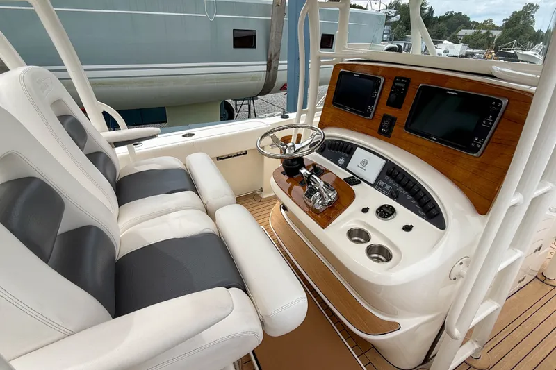 Slide: The Image of Interior view of 2013 Boston Whaler 32 Justice boat cockpit with dual seats and control panel. - 12